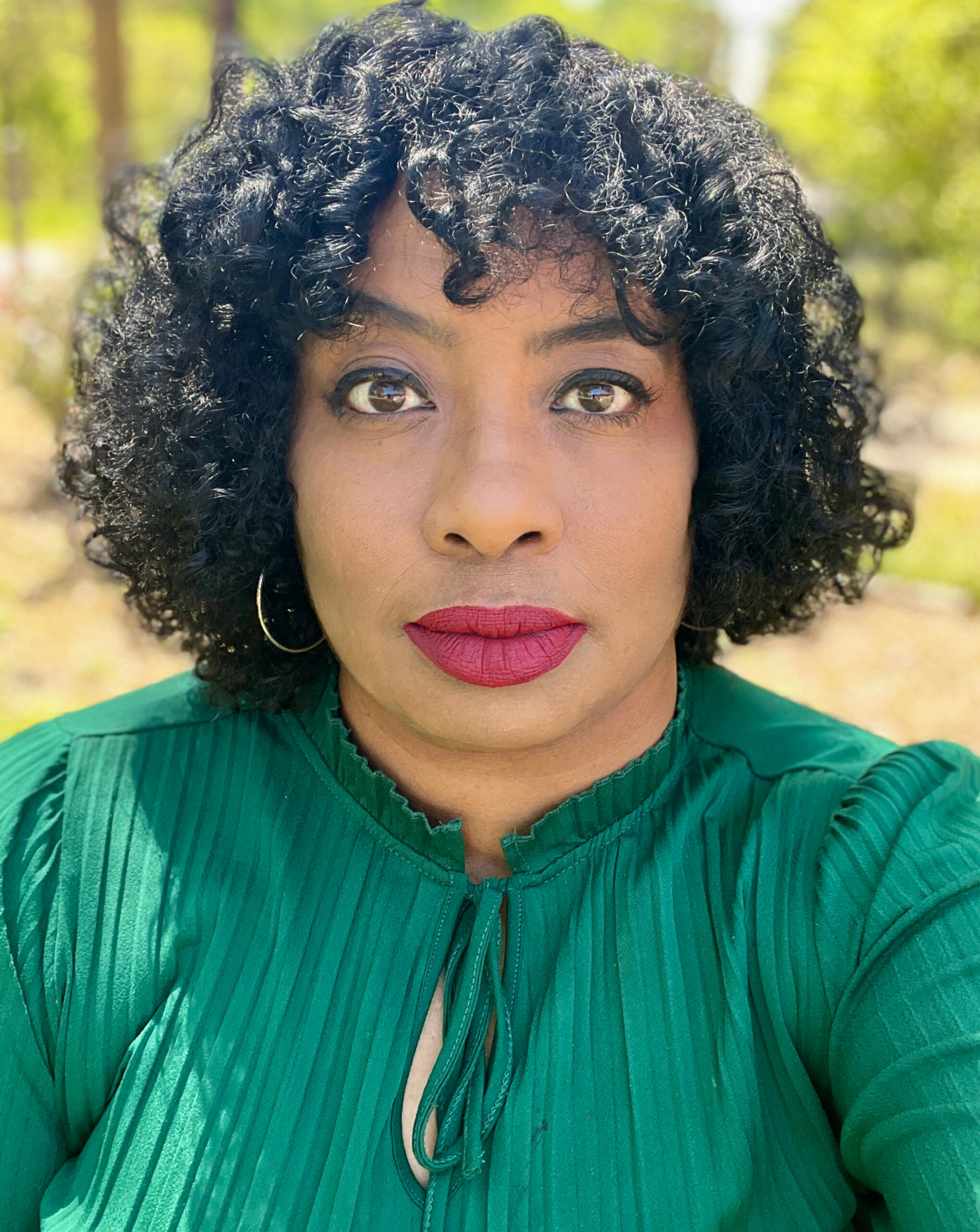 Masha Dowell | Medical Content Strategy & Healthcare Communications Expert Masha Dowell, Director of Medical Content Strategy, wearing emerald green blouse against natural background